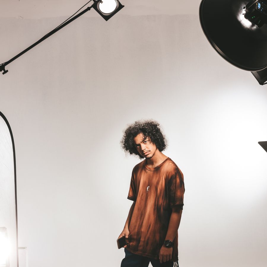 Man with black curly hair posing in photo studio — stock photo for Export a Design