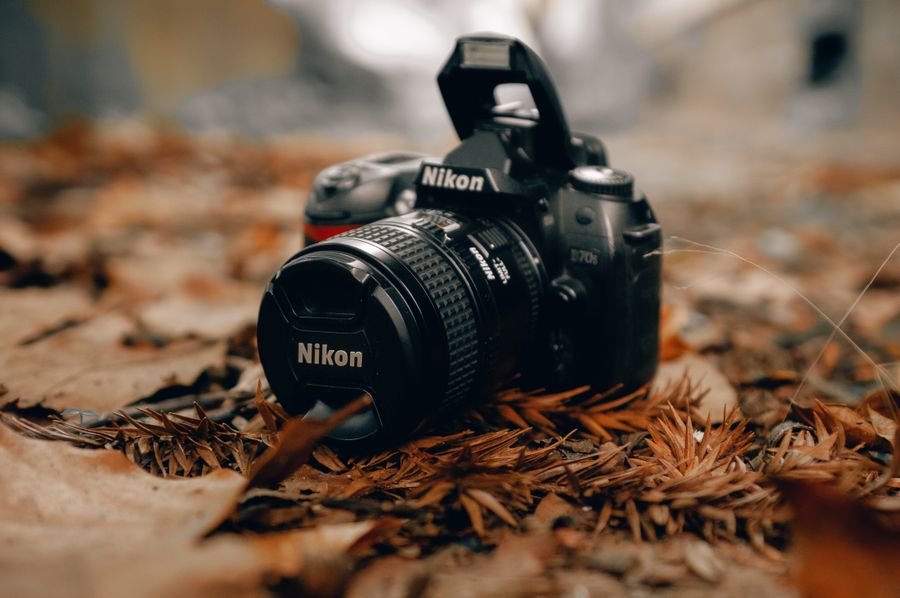 Close up shot of a nikon dslr camera — PhotoAI Company — AI photo & design editor layers-panel mockup