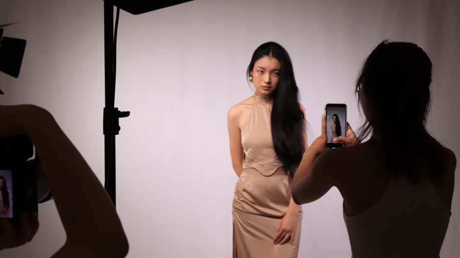 Beautiful woman in beige sleeveless dress — Documents in use