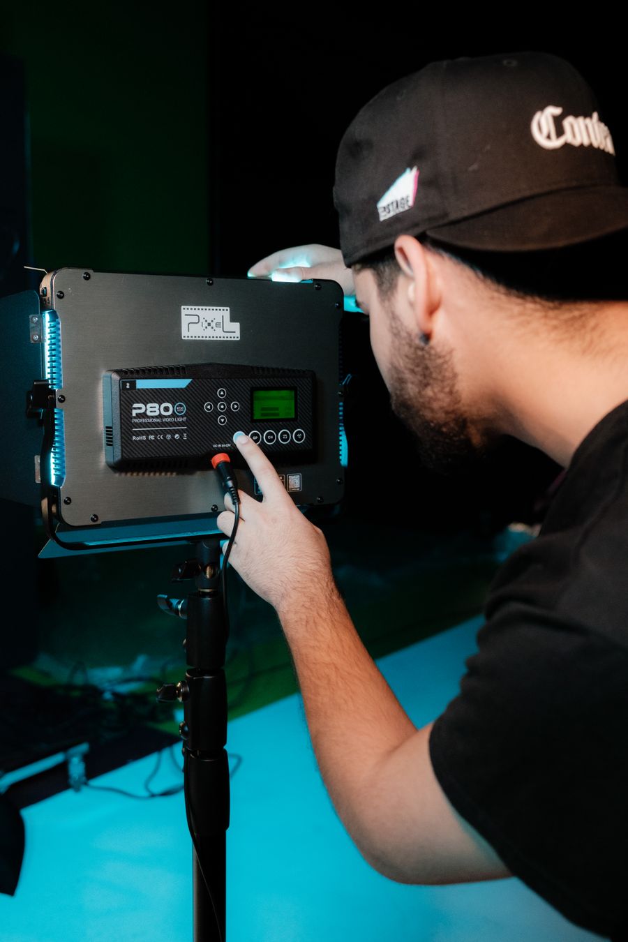 Man setting video light in studio — Suggest a Color Palette browser mockup