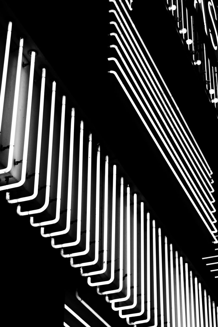 A black and white photo of a building with neon lights — PhotoAI Company — AI photo & design editor motion card