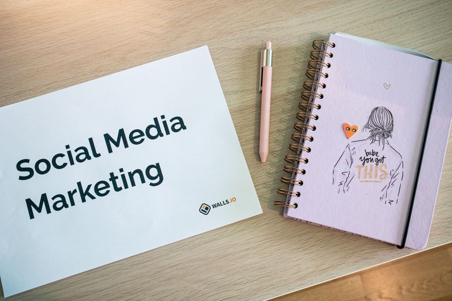 Journal lying on wooden desk next to door plaque and pen — stock photo for Instagram Posts & Stories templates