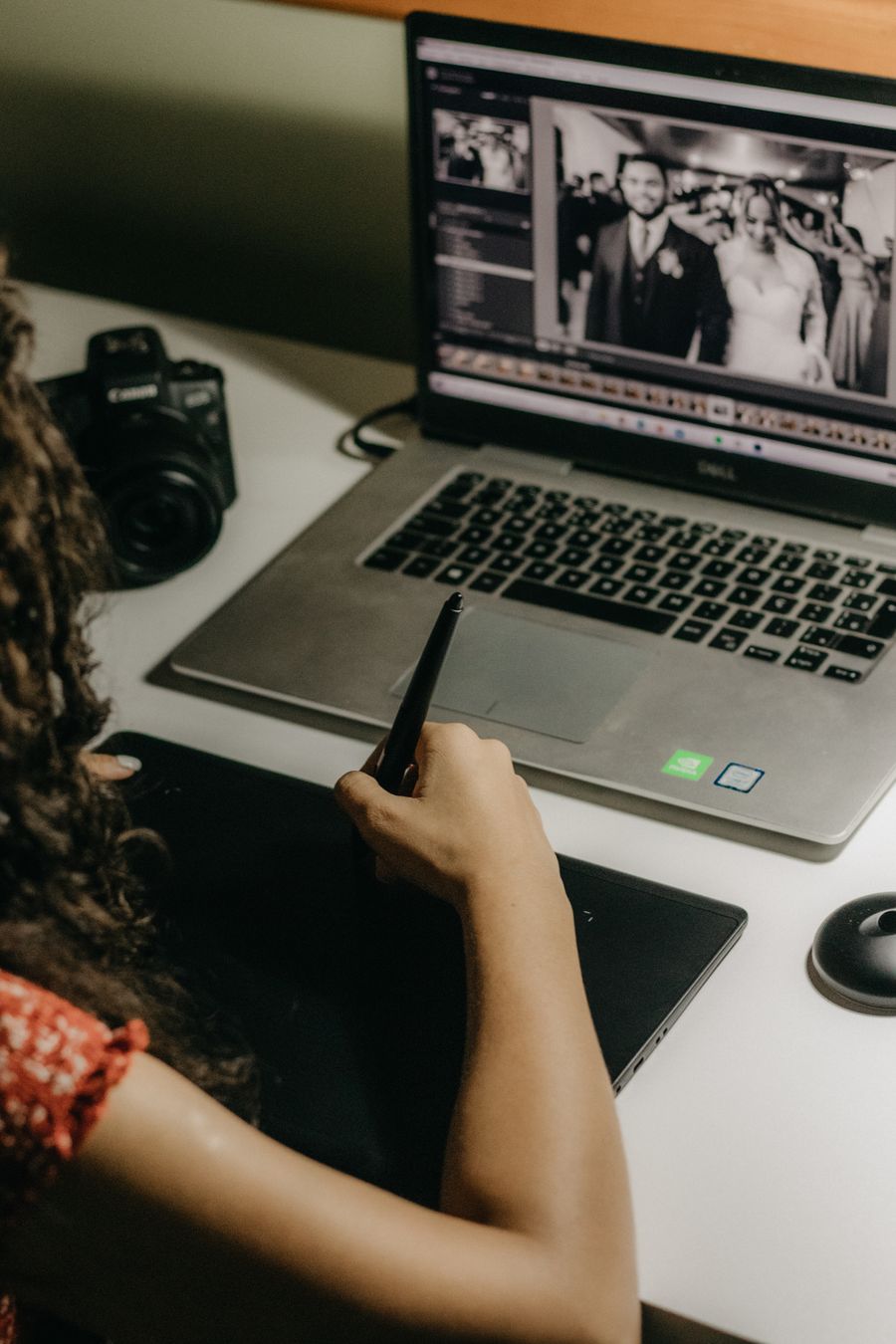 Woman editing photos on laptop — Remove Background dashboard mockup