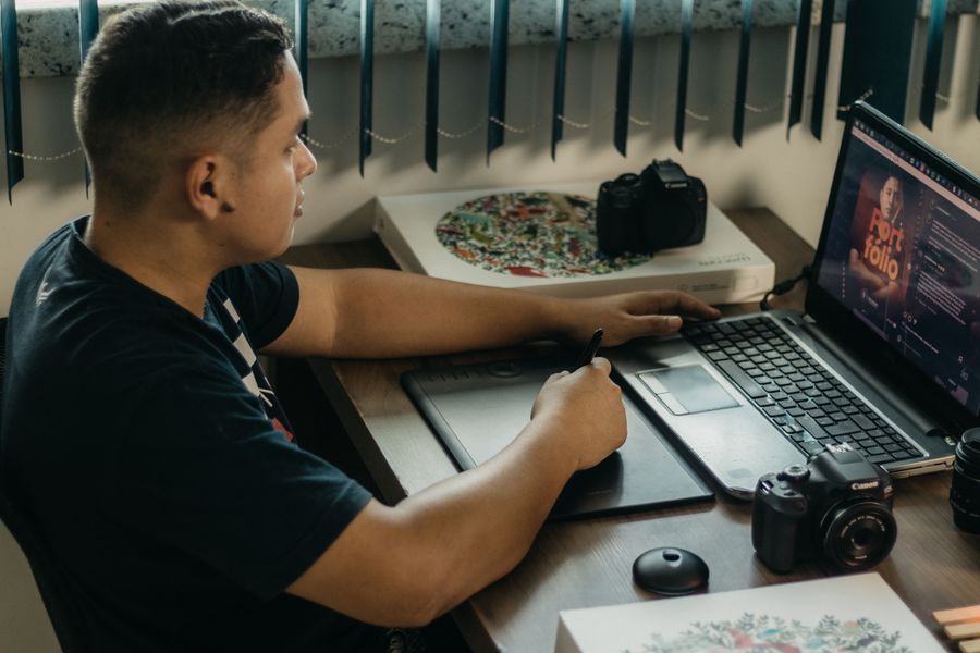 Man using wacom tablet to edit photos on laptop — stock photo for Advertisements templates