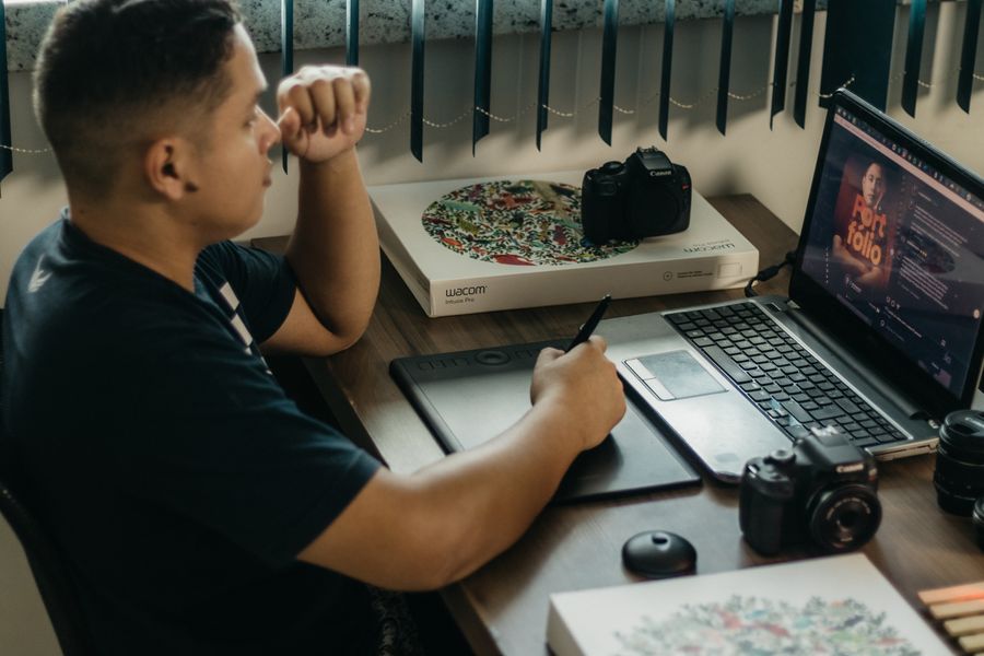 Photographer working on wacom tablet and laptop on desk — stock photo for Business Cards templates