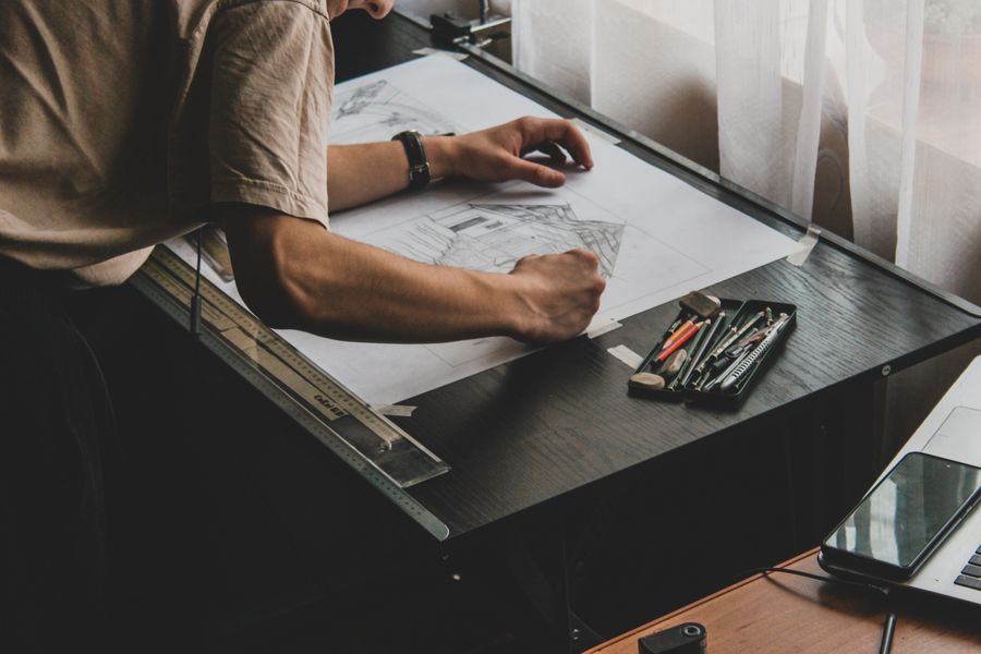 An architect working at a drafting table — Video templates phone mockup