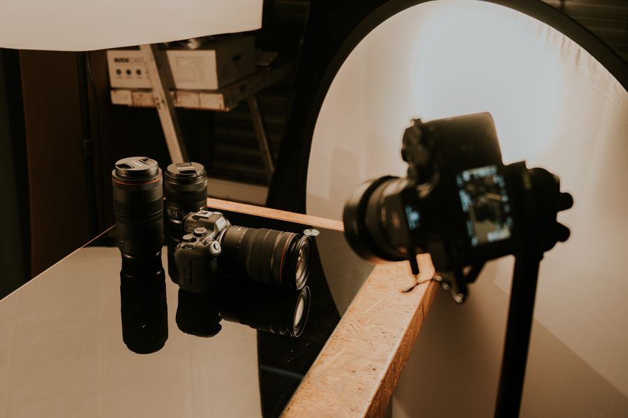 Cameras and lenses on table — Drop product shots straight onto the canvas