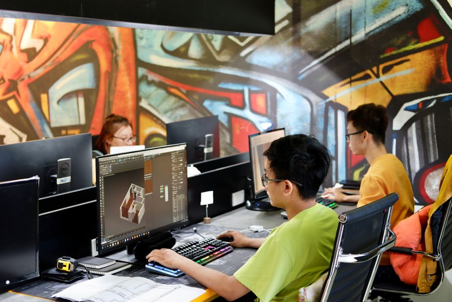 Young people sitting and working on computers — PhotoAI Company — AI photo & design editor layers-panel mockup