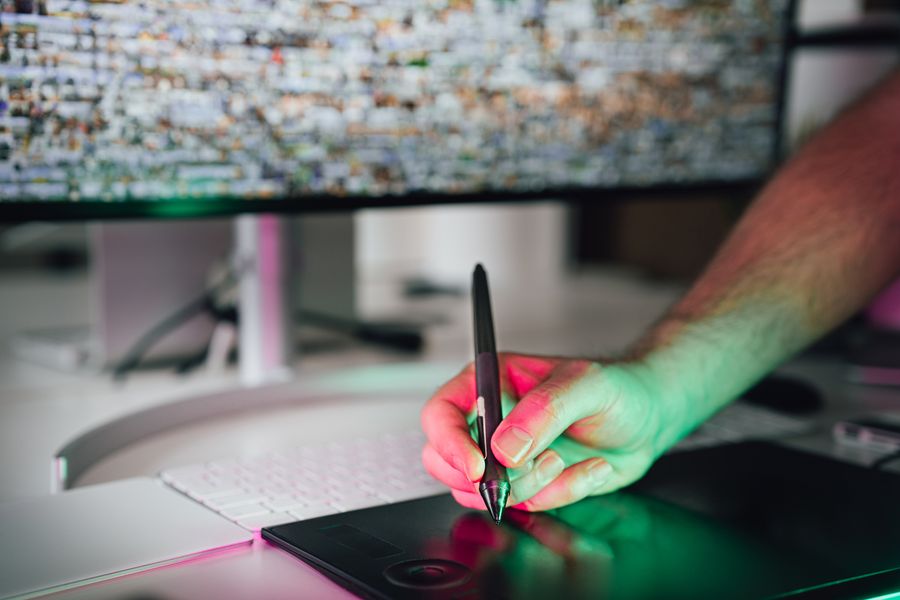 Male hand drawing on a graphic tablet with a pencil — Brand Kits templates resize-canvas mockup