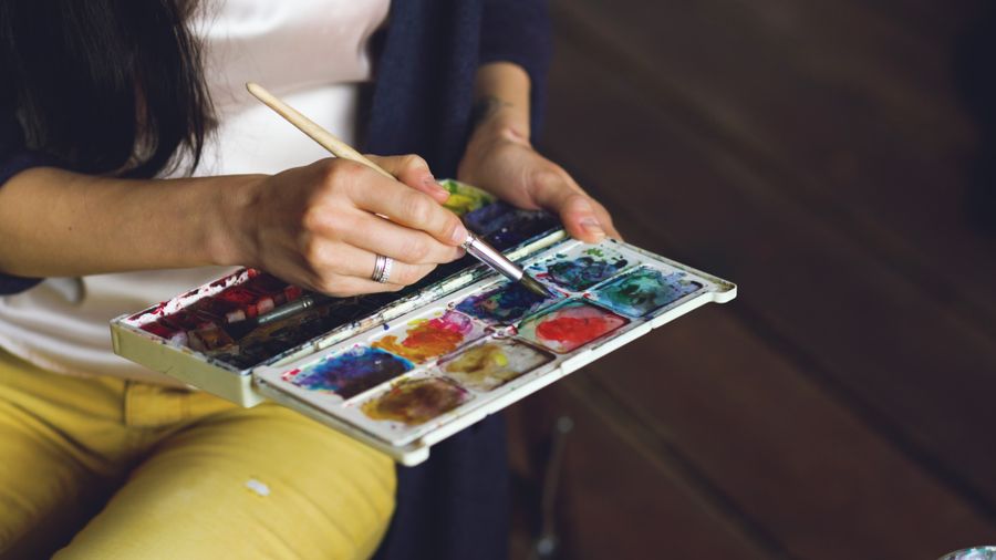 Close up of a woman mixing paint on a palette — Every photoaicompany design tool layers-panel mockup