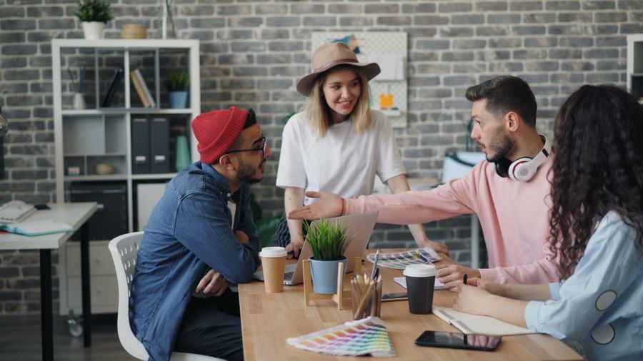 Office workers discussing at a table with a laptop and color swatches — Instagram Posts & Stories templates motion card