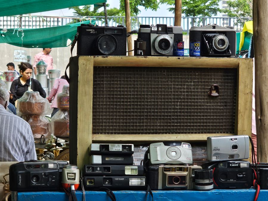 A man is selling old cameras and other items — PhotoAI Company — AI photo & design editor export-dialog mockup