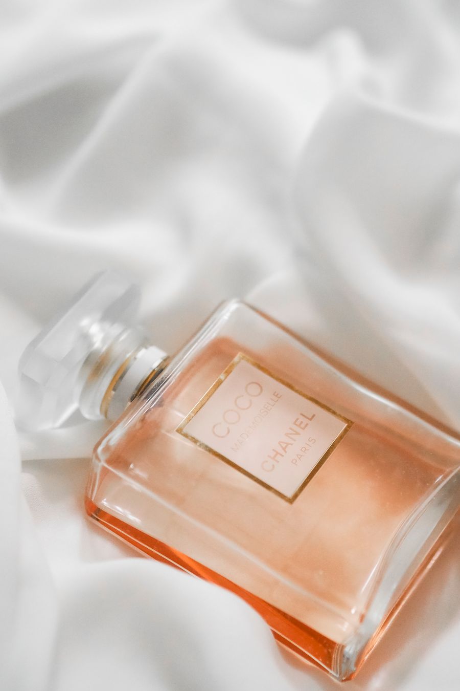 Elegant perfume bottle on soft silk fabric — stock photo for Every photoaicompany design tool