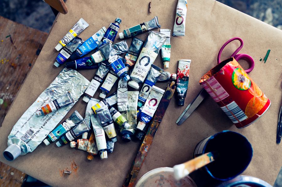 Collection of acrylic paint tubes on a table — Remove Background editor mockup