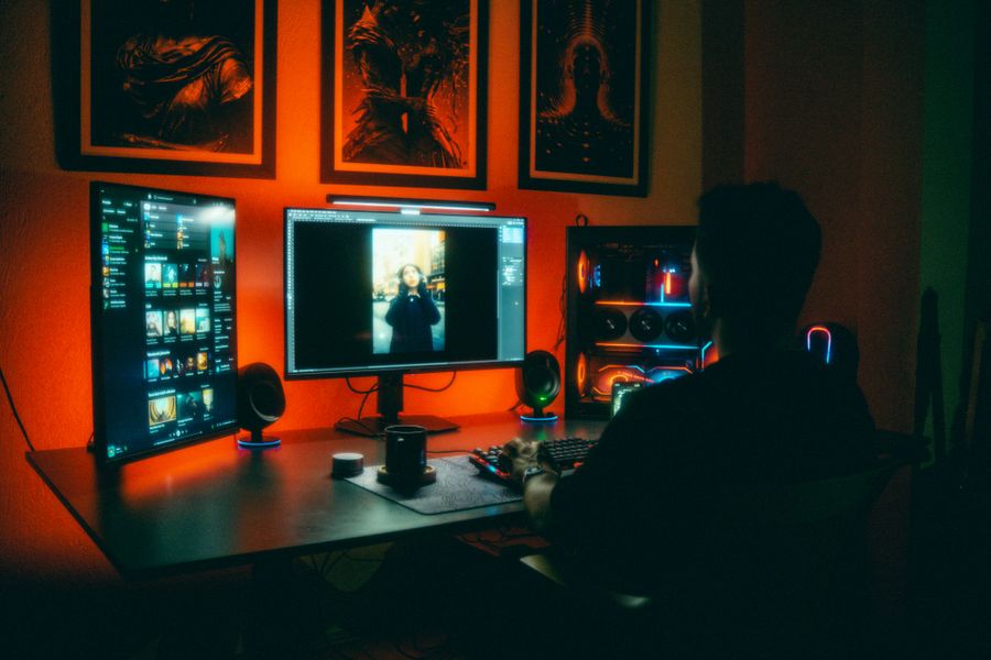 Digital artist editing in neon lit workspace — stock photo for Every photoaicompany design tool