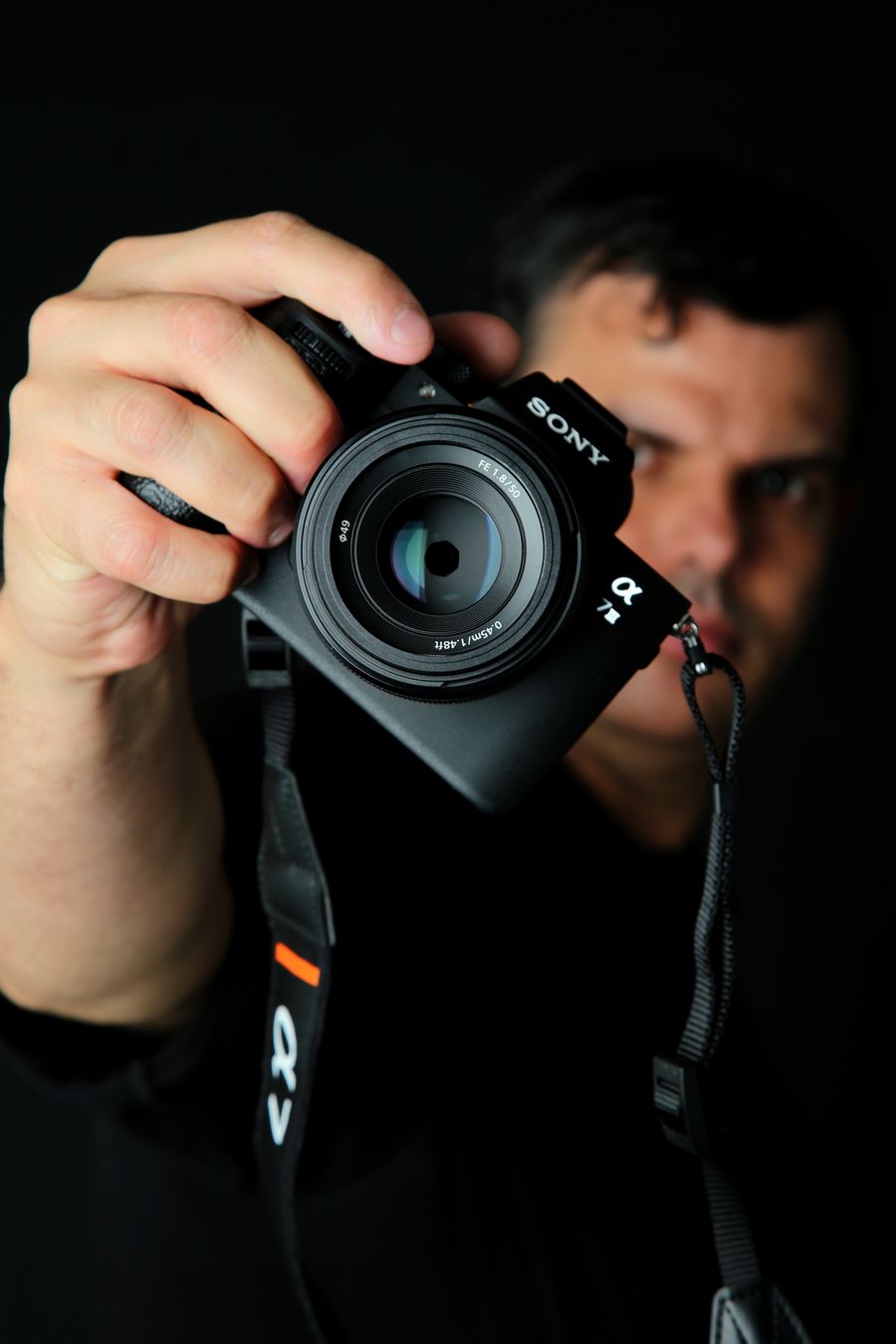 Close up portrait of a photographer holding camera — Remove Background phone mockup
