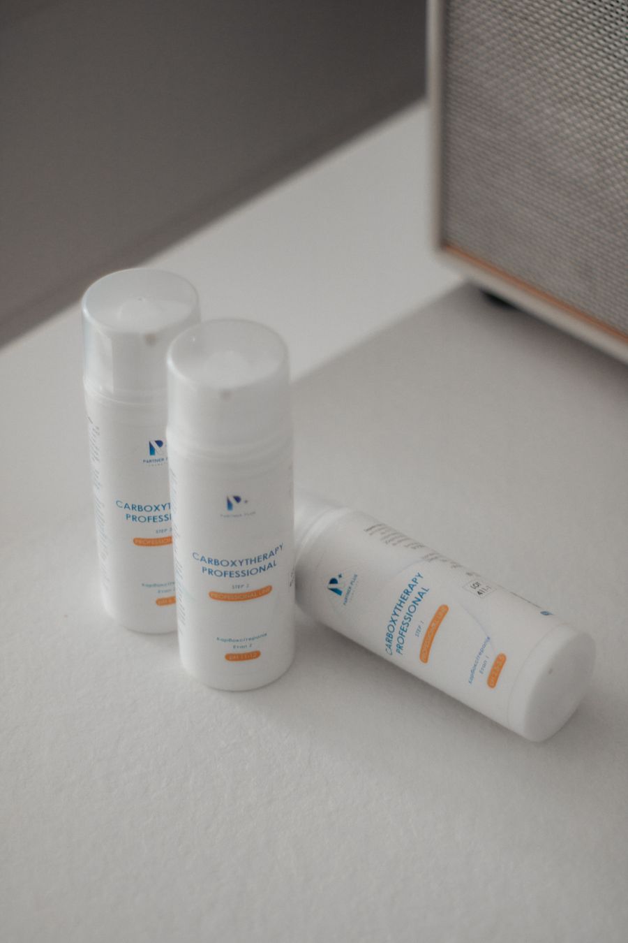 Three cosmetic bottles on white surface — stock photo for Add a Shape
