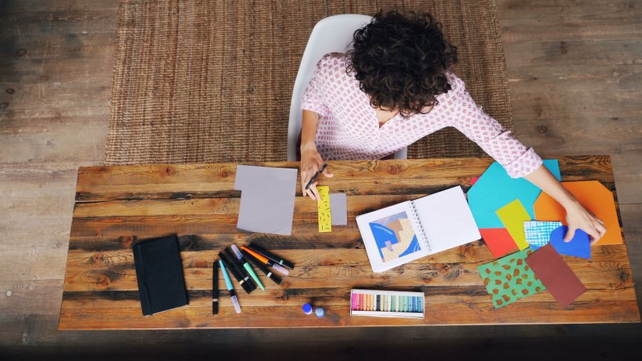Top view of woman crafting with colorful paper at desk — stock photo for PhotoAI Company — AI photo & design editor