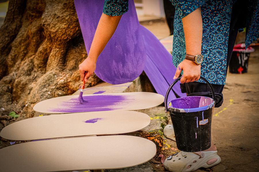 Person painting with purple paint outdoors — Everything in the editor, honestly described resize-canvas mockup