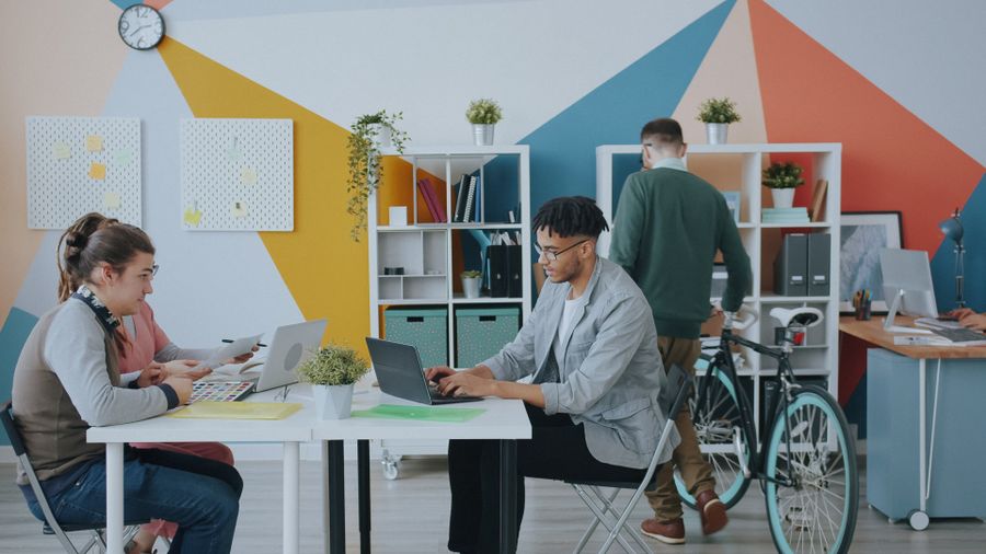 Modern coworking space with diverse team working — Terms of Service editor mockup