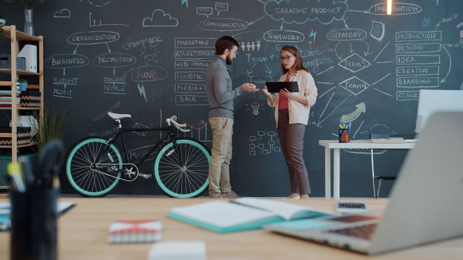 Creative office brainstorming session with chalkboard — Brand Kits templates phone mockup