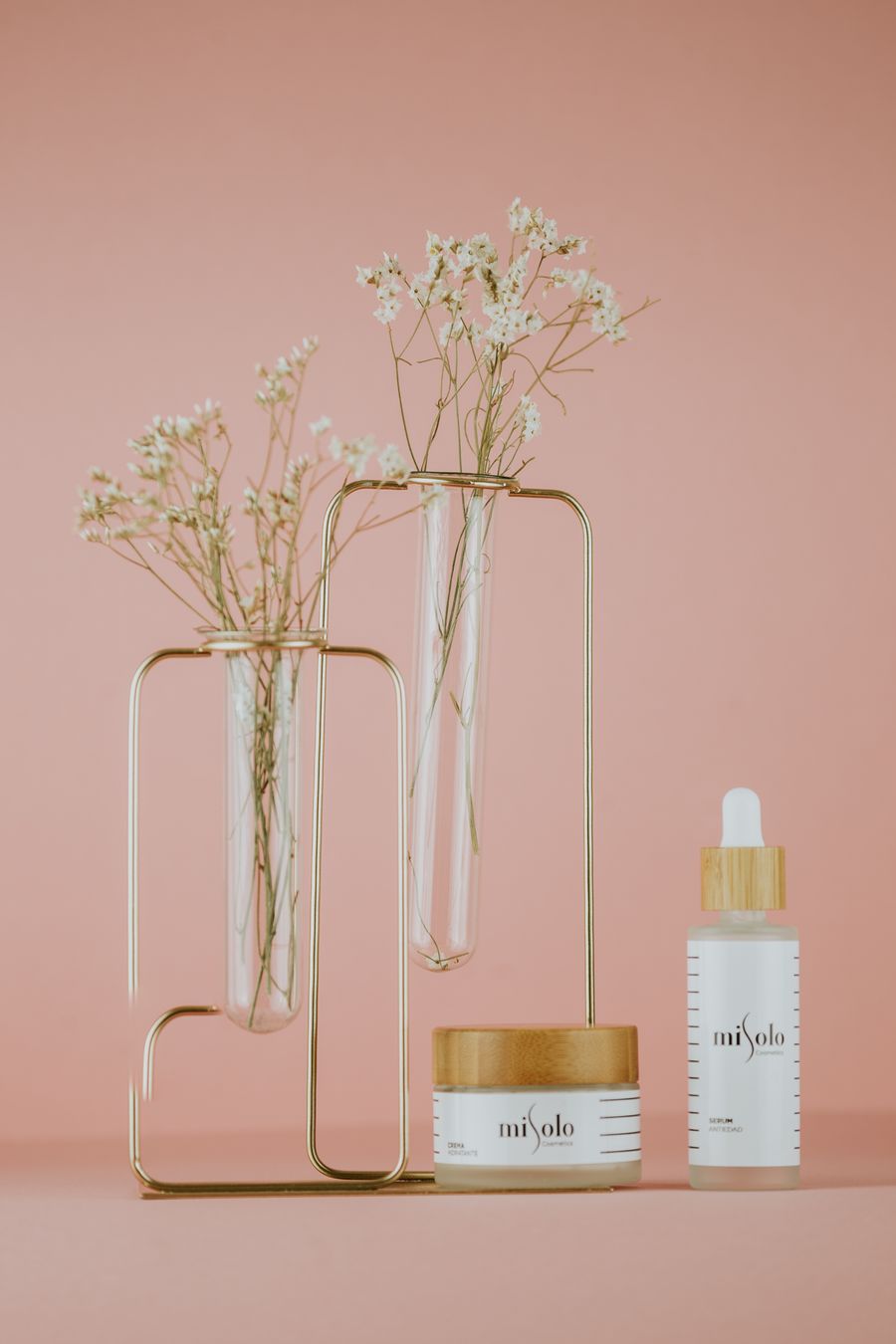 White labeled bottle near the white flowers — Start designing free layers-panel mockup