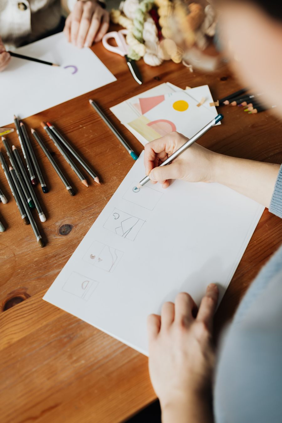 Crop anonymous female designers making drawings with pencils at work — stock photo for Align Elements