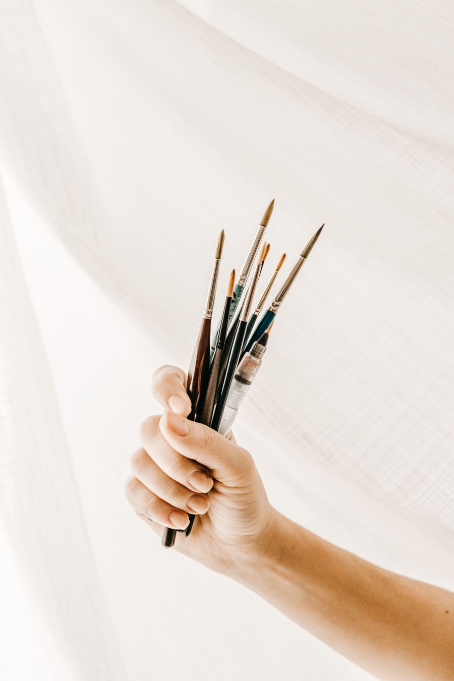 Crop artist with brushes against cloth — before Browse Design Templates