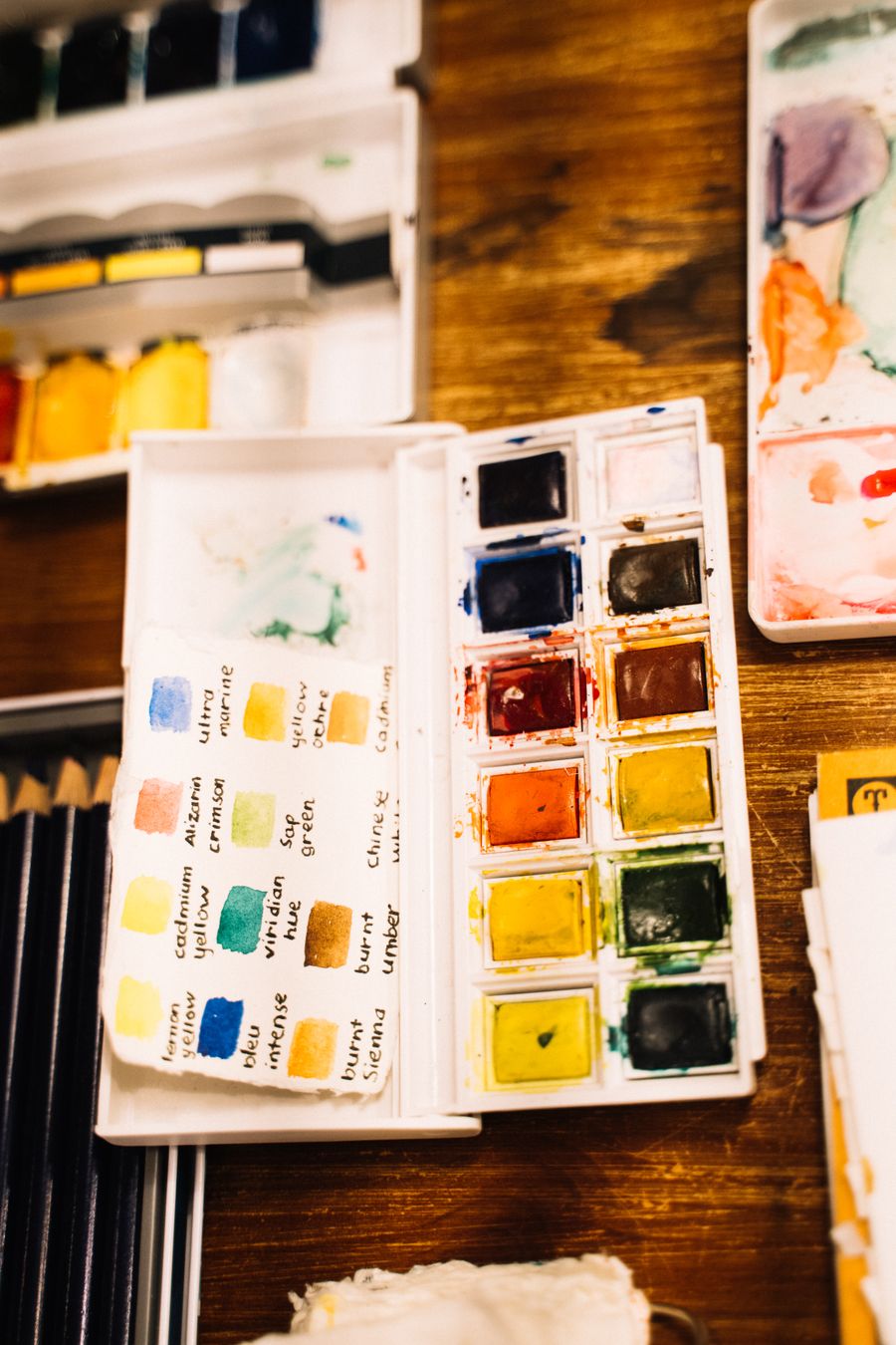 Watercolors with color indication on a wooden surface — Every photoaicompany design tool template-card mockup