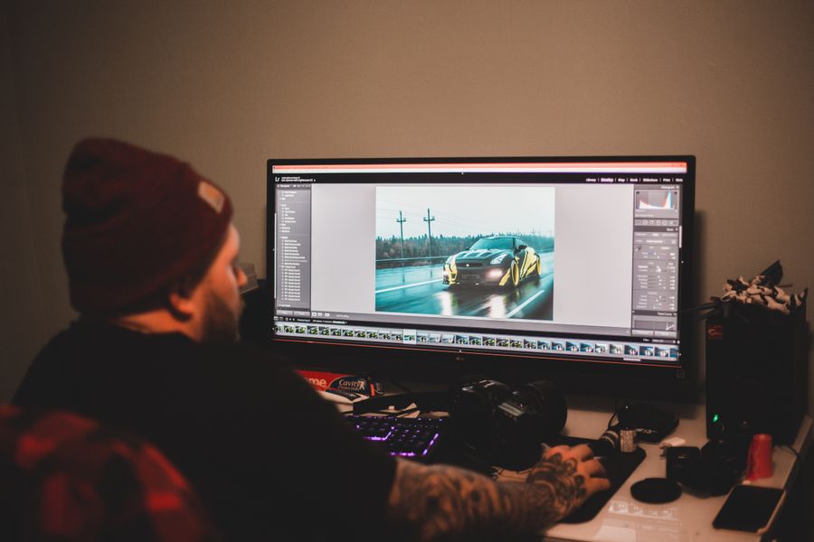 Faceless man working on computer with montage — stock photo for Export a Design