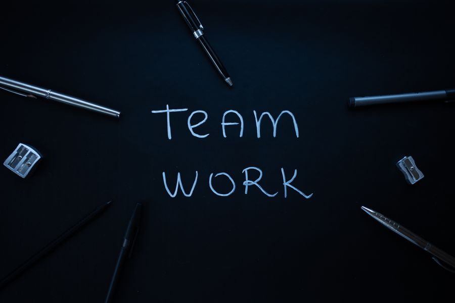 Silver and black pens on a black surface — Add Text editor mockup