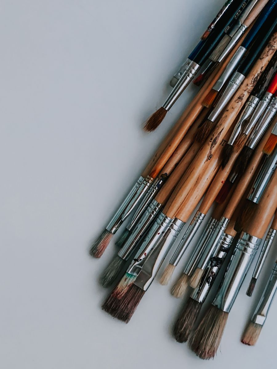 Set of various brushes placed on white desk in art studio — Everything in the editor, honestly described browser mockup