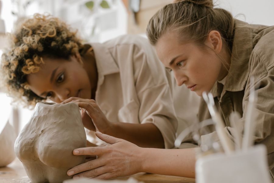 Women sculpting buttocks in clay — Every photoaicompany design tool phone mockup