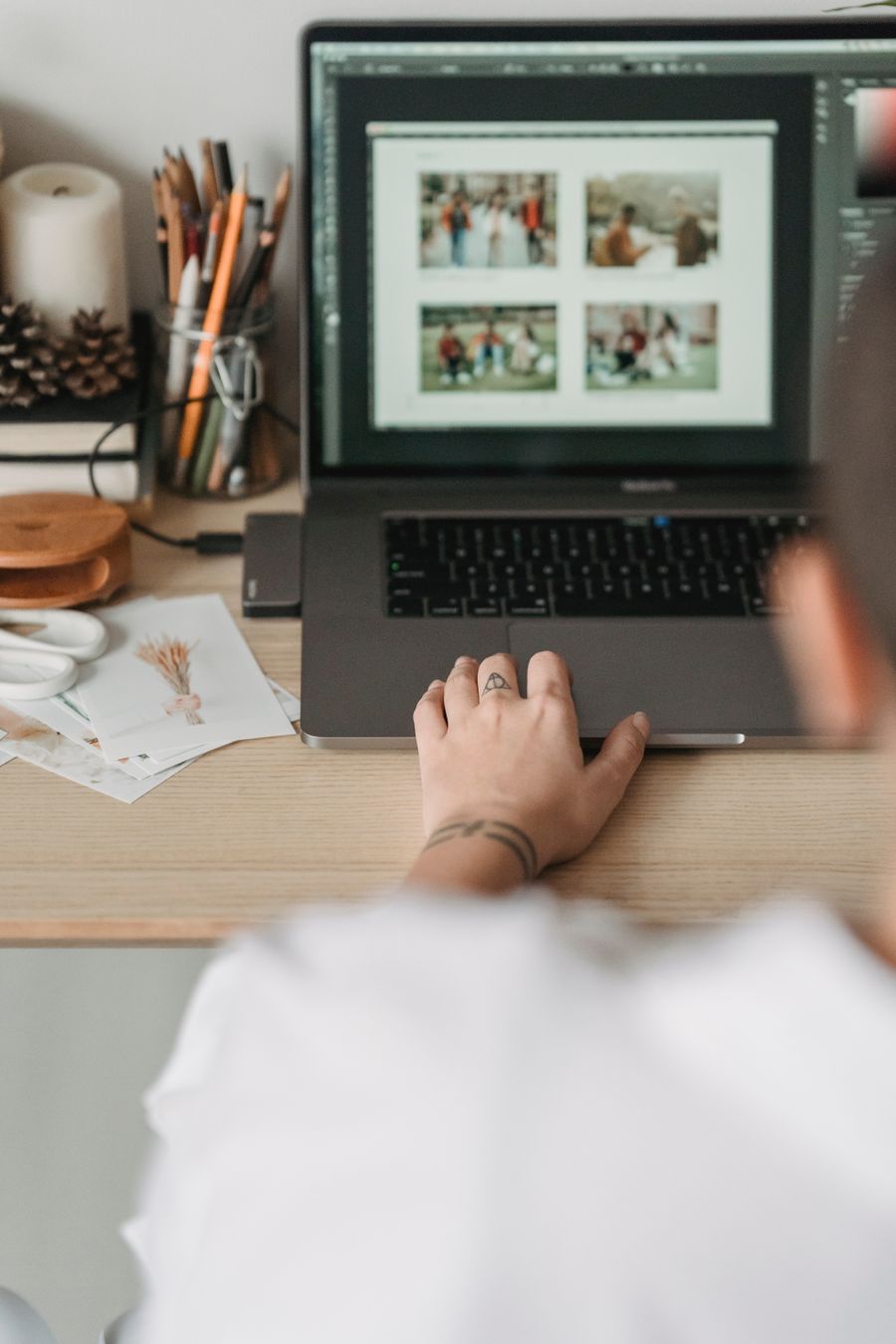 Crop faceless person editing photos on laptop — before Export a Design