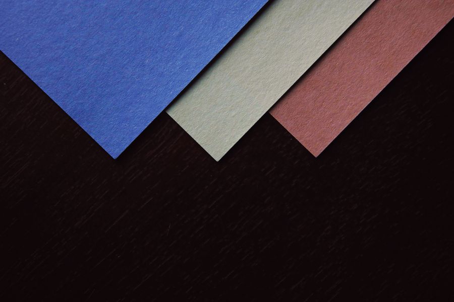 Close up shot of colored papers on a black surface — Add Text annotated figure
