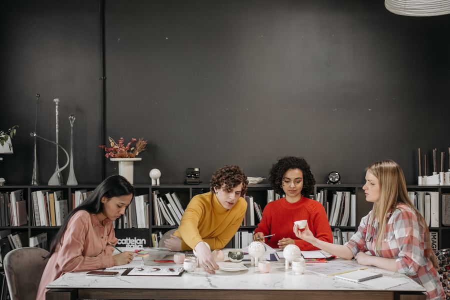 A team sitting on the table — PhotoAI Company — AI photo & design editor motion card