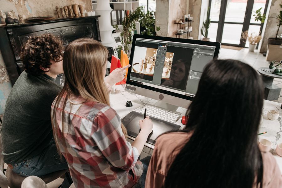 People sitting and working in front of a desktop computer — stock photo for Add Text
