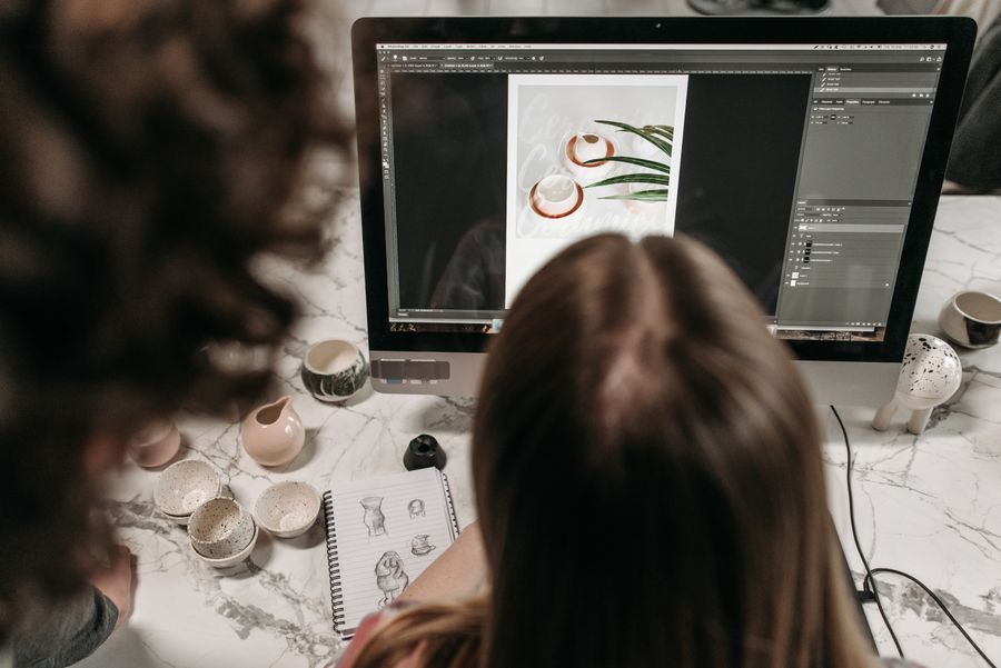 A person editing a photo using a computer — Create a Design layers-panel mockup