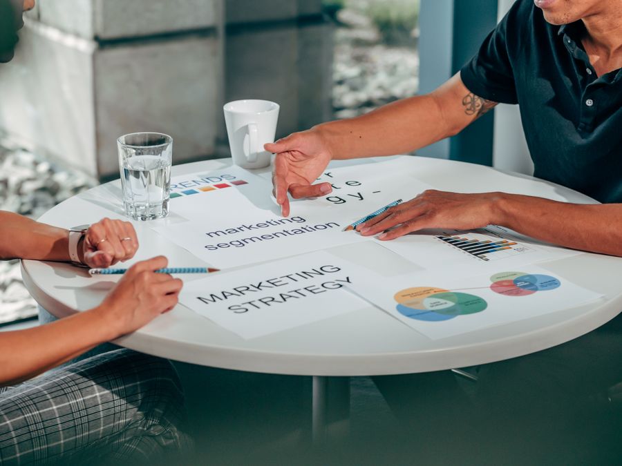 2 persons discussing at the table — Brand Kits annotated figure