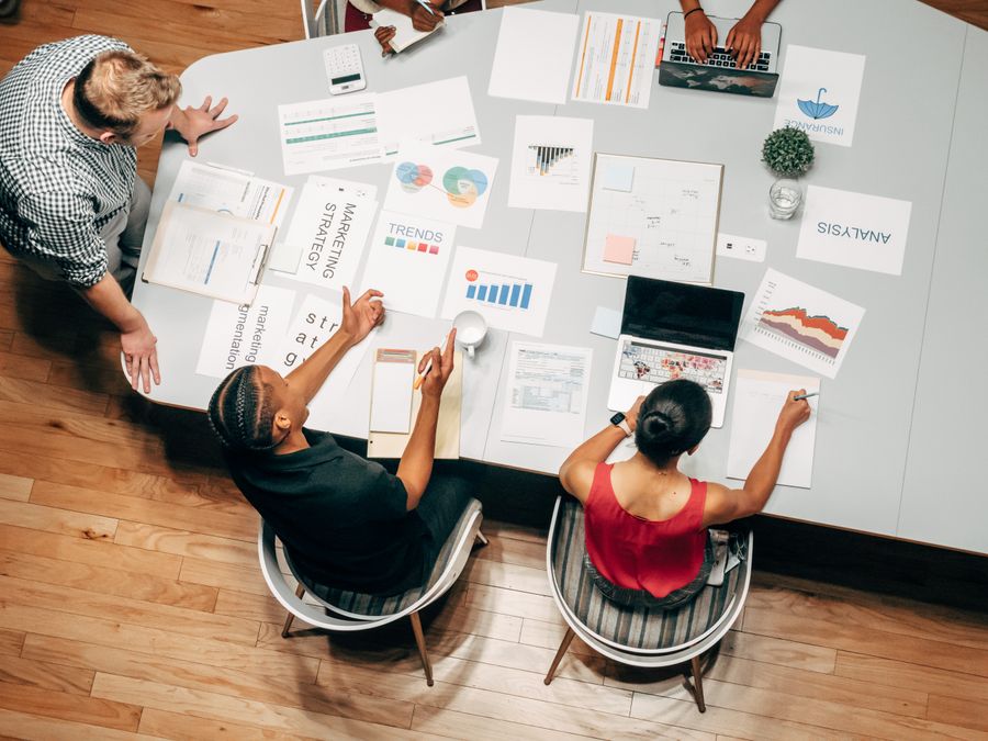 Overhead shot of people in a meeting — Templates that teach annotated figure