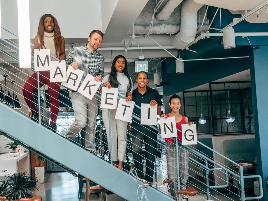 Coworkers standing on a stairway — Create a Design motion card