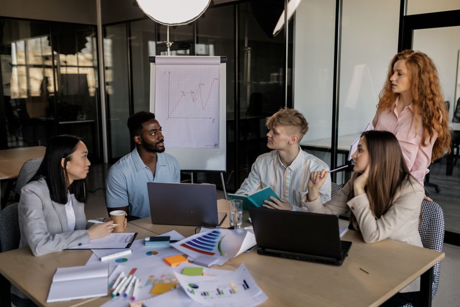 A group of people having a meeting in the office — Browse Design Templates template-card mockup