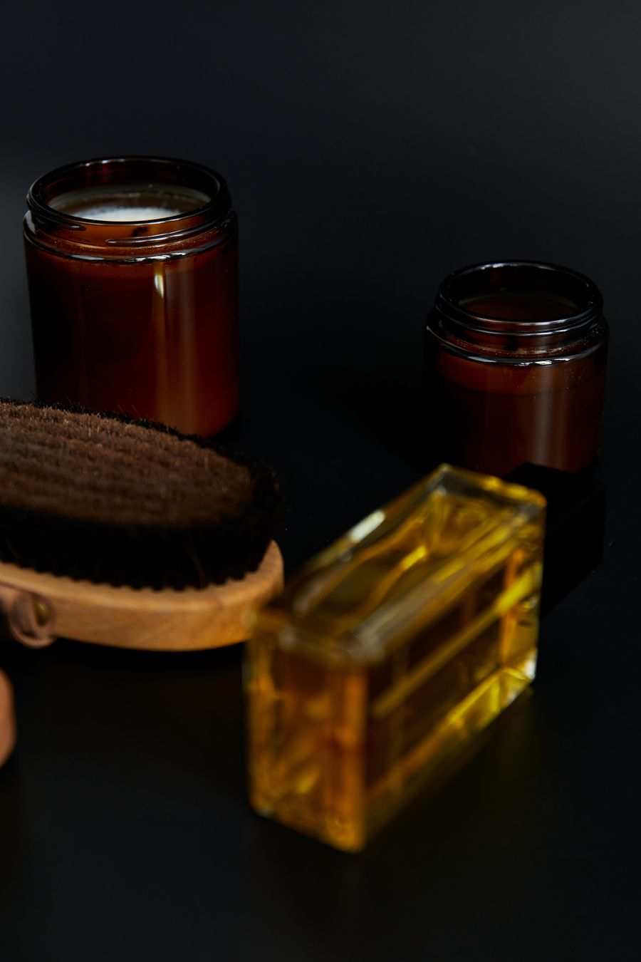 Bottles of skin oil and cream on black — Welcome back dashboard mockup