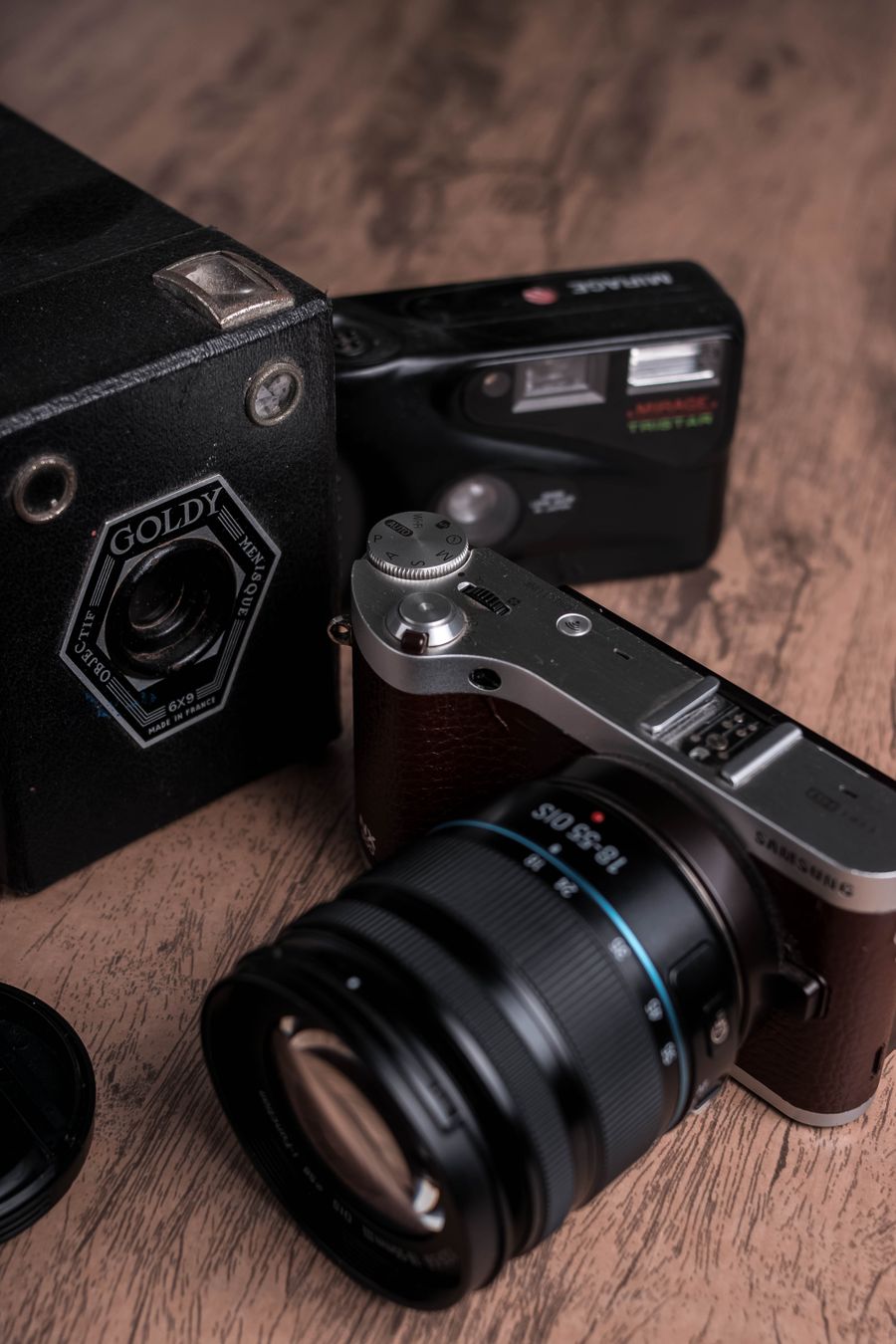 Cameras on a wooden surface — Welcome back editor mockup