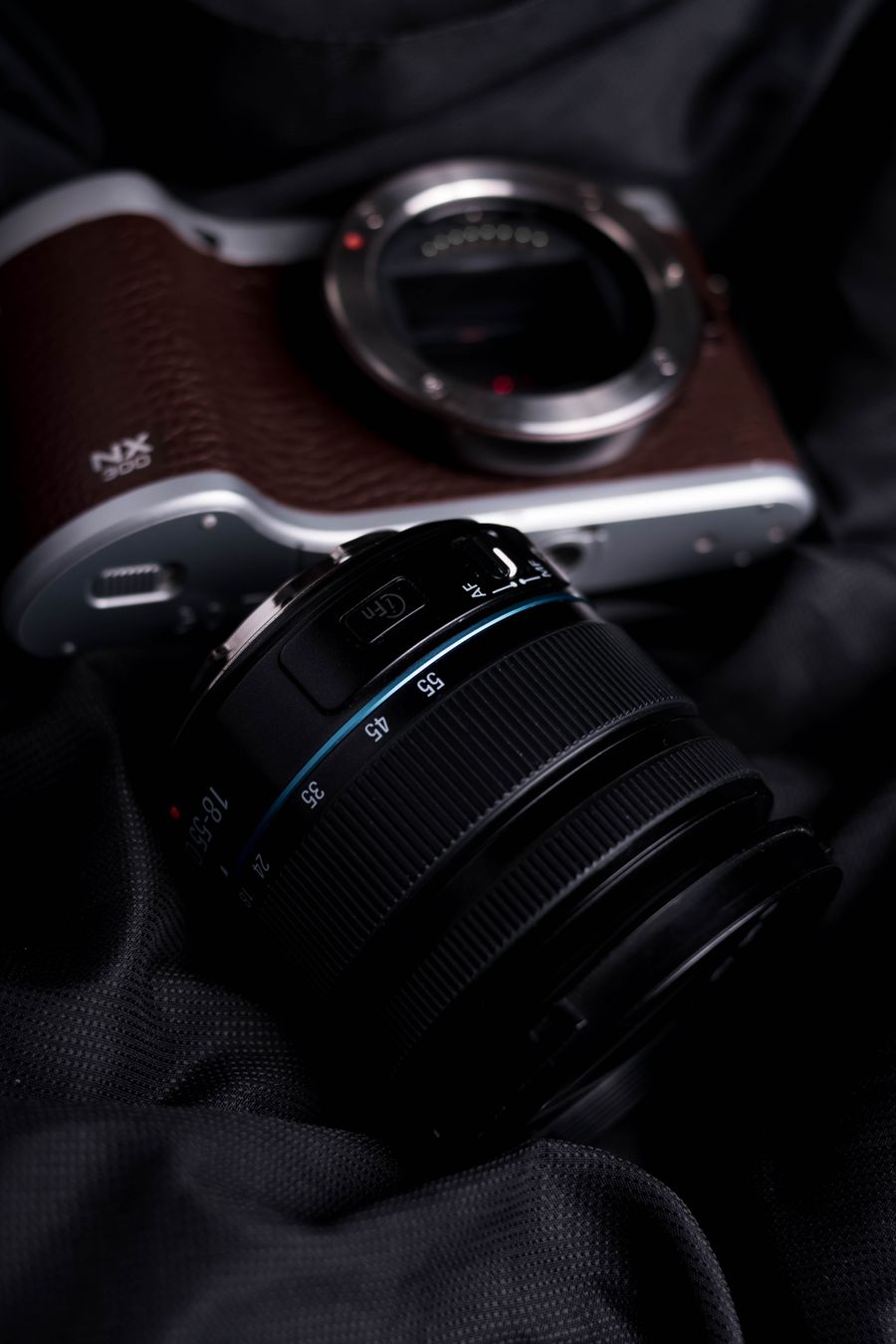 Black camera lens and and a camera on black textile — stock photo for Brand Kits templates