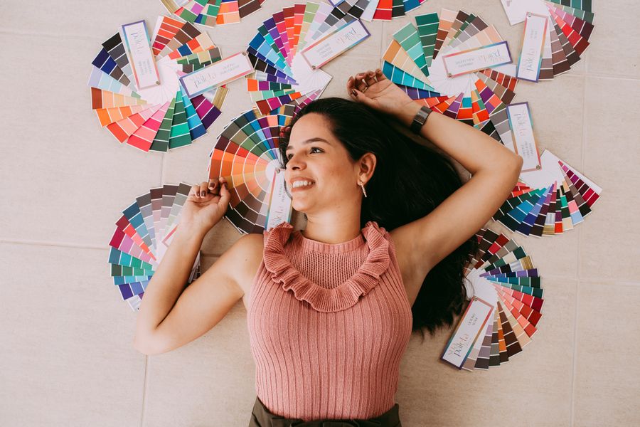 A woman lying on color pallets — Simple pricing, no watermarks, no gotchas browser mockup